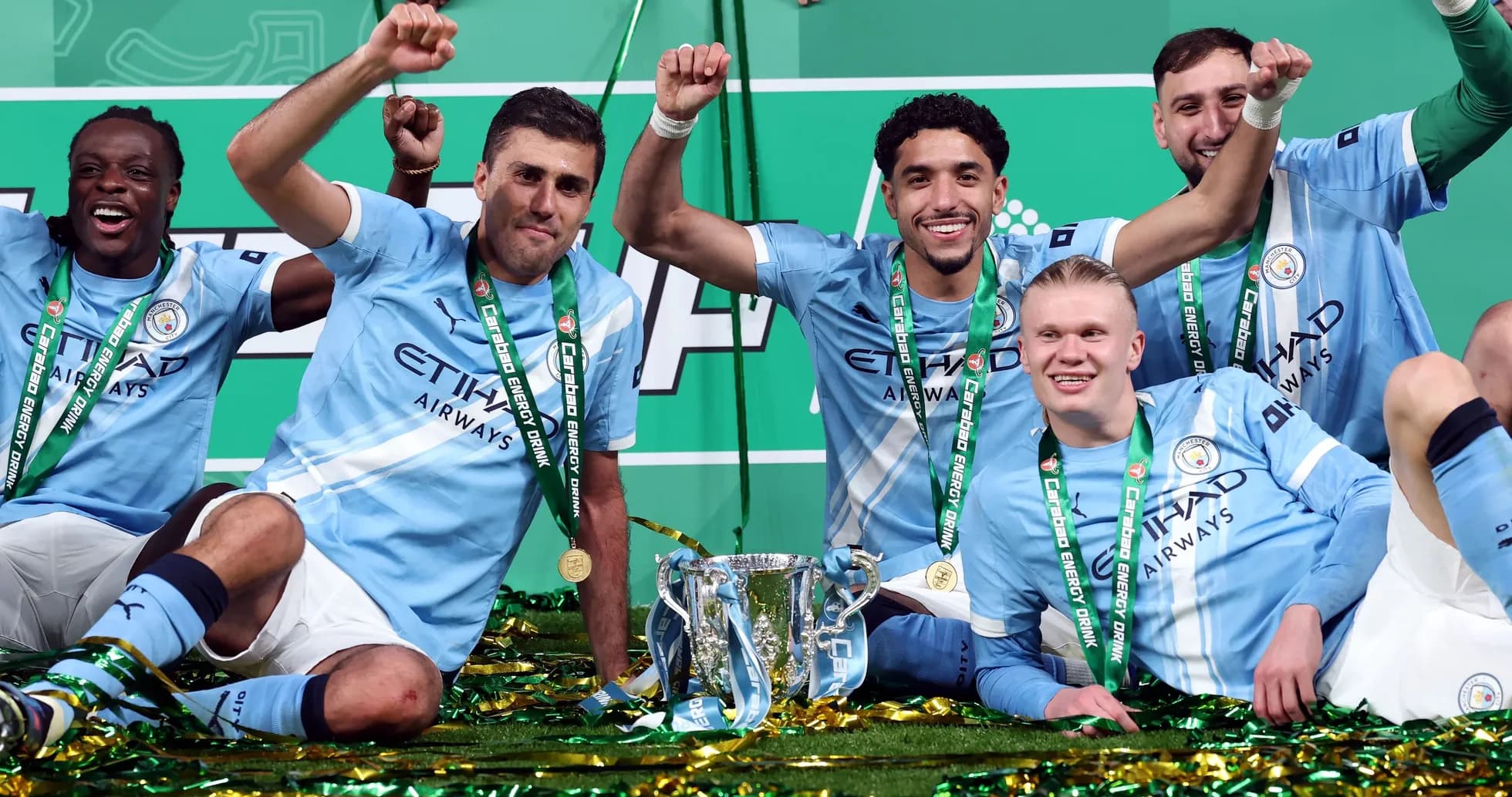 Manchester City players celebrating with trophy