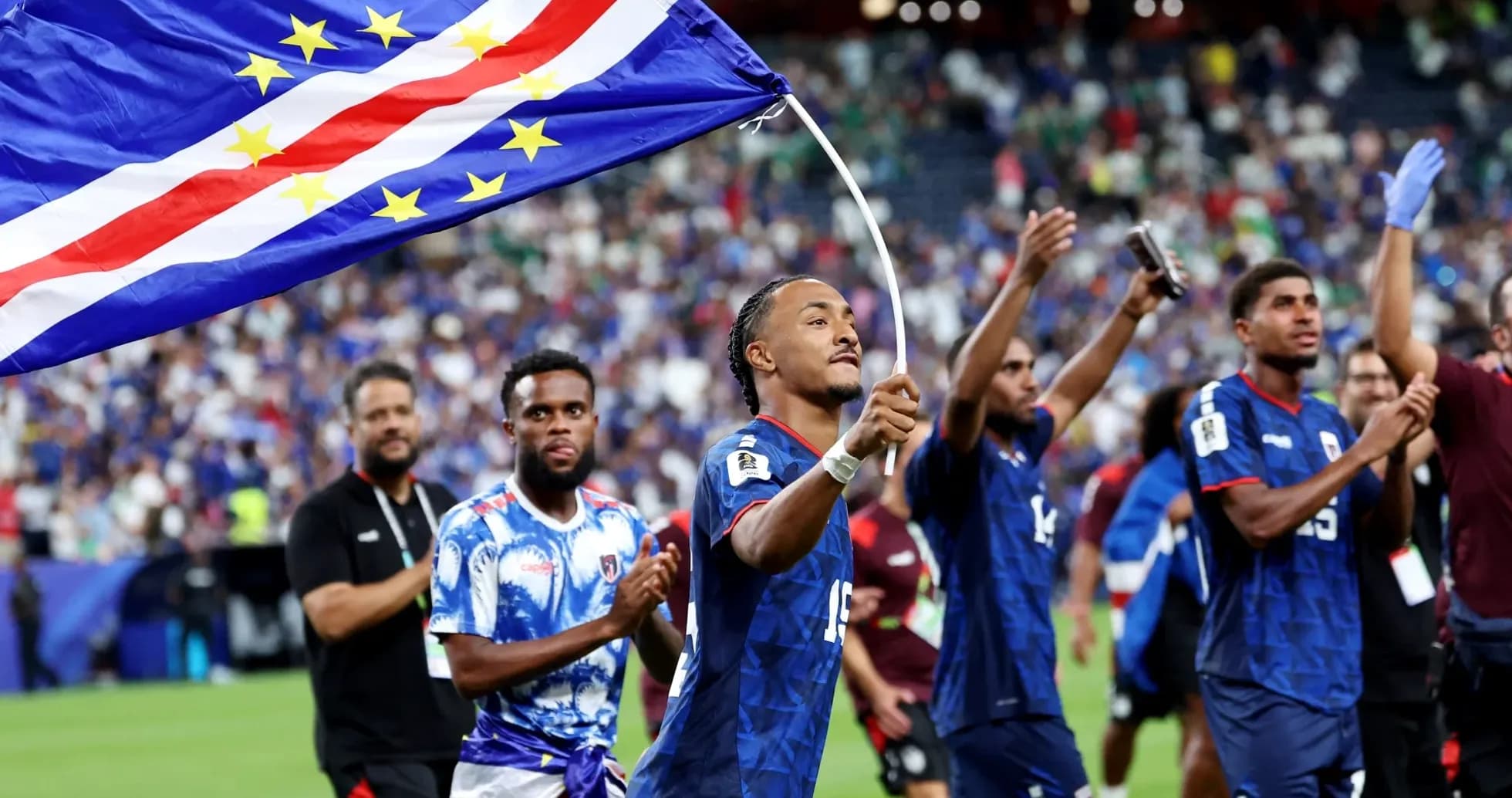 Player celebrating with Cape Verde flag after match