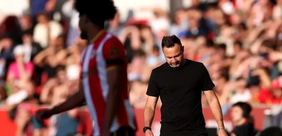Manager walking past player during match
