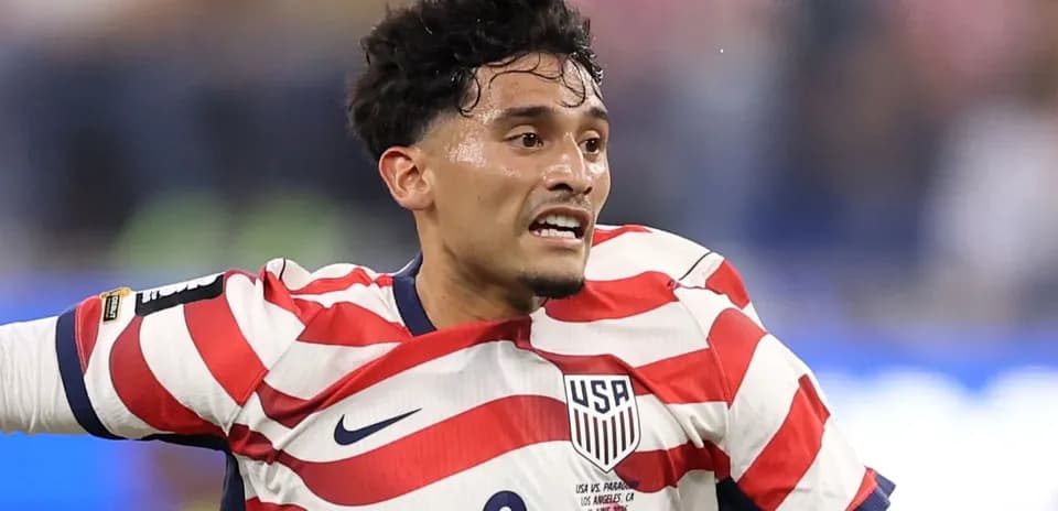 Player in USA jersey celebrating on the field