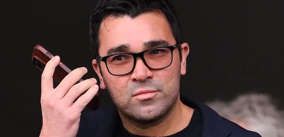 Person on phone during event with serious expression