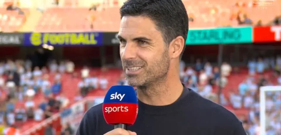 Coach speaking during pre-match interview on field
