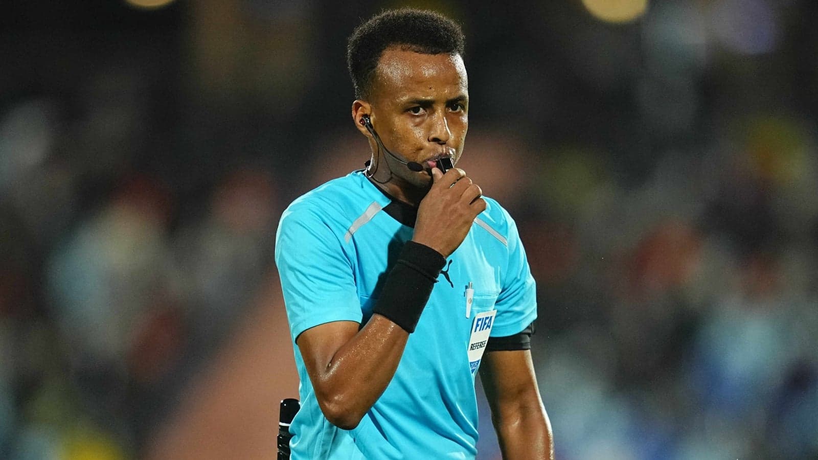 Referee blowing whistle during a match