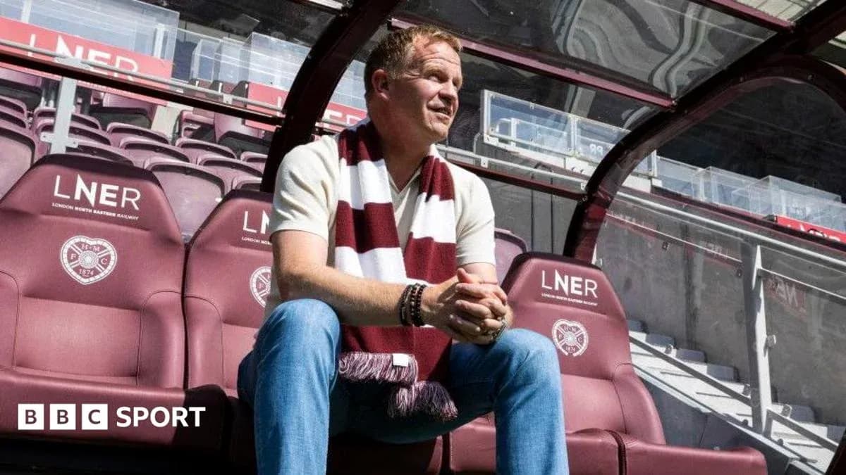 Manager sitting on bench at stadium