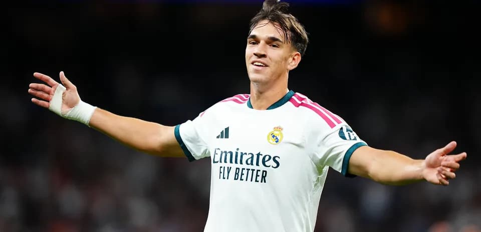 Player celebrating in Real Madrid jersey on field