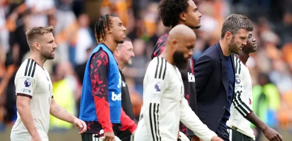Players and staff walking off the pitch after match