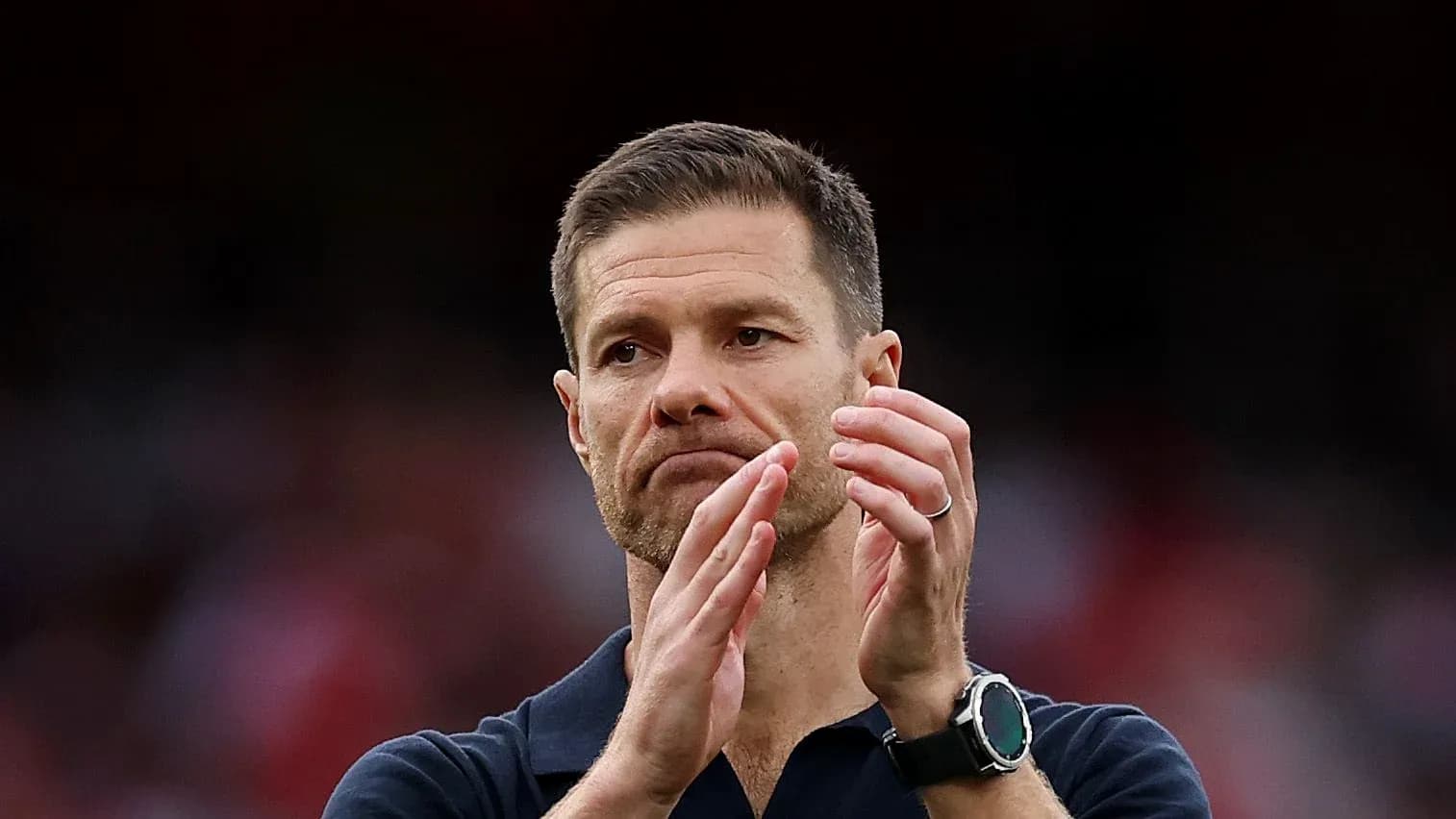 Coach applauding during match at stadium