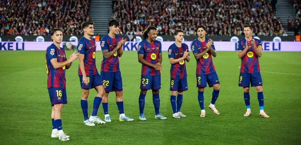 Barcelona players applauding fans during a match