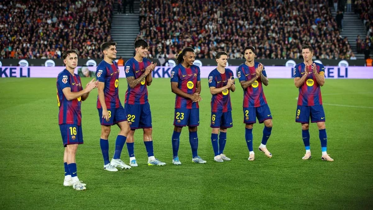 Barcelona players applauding fans during a match