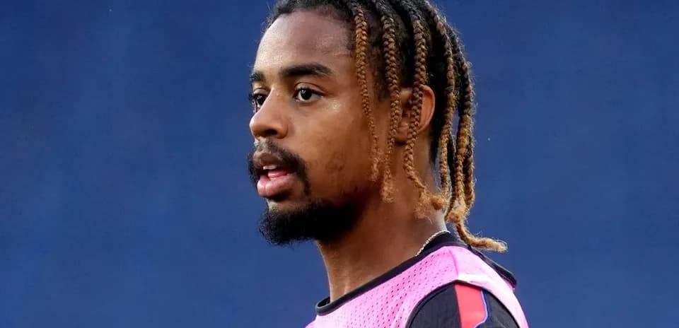 Player wearing a pink training vest during practice
