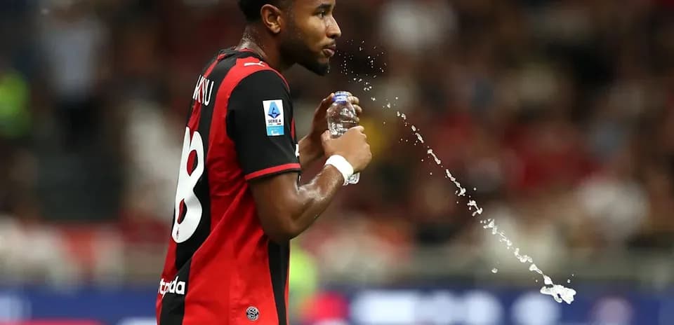 Player spraying water from bottle during match