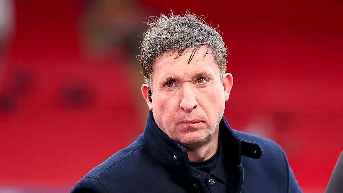 Man in a dark coat at a sports venue