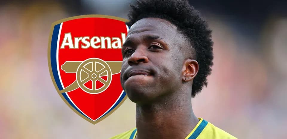 Player standing in front of Arsenal logo