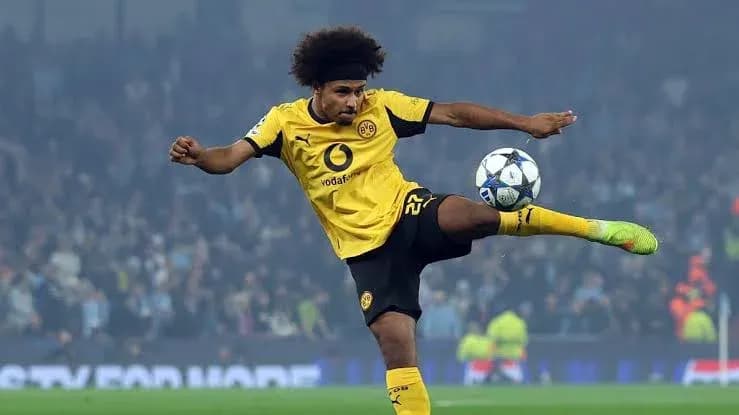 Player in yellow kit kicking soccer ball during match