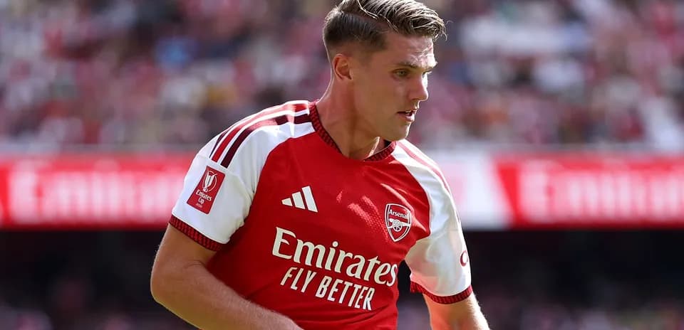 Arsenal player in red jersey during match action