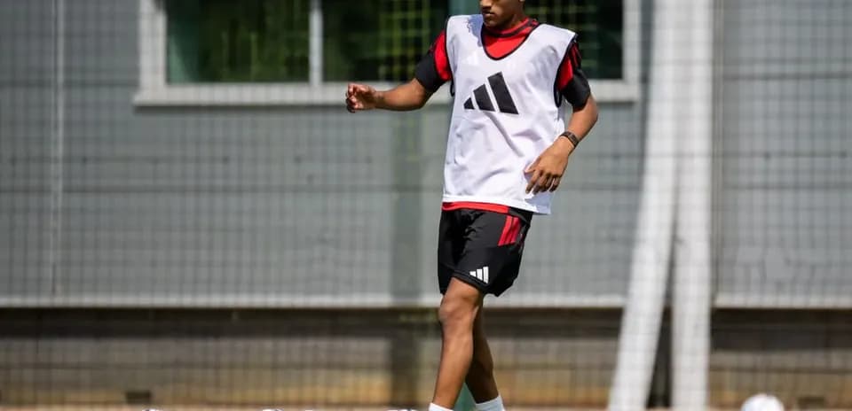 Player training on pitch with soccer balls