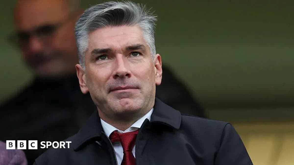 Man in suit observing from the stands