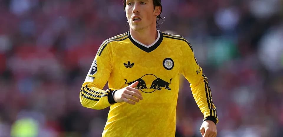 Player running in yellow kit during match