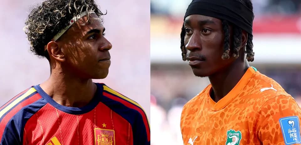 Two soccer players in national team jerseys facing each other