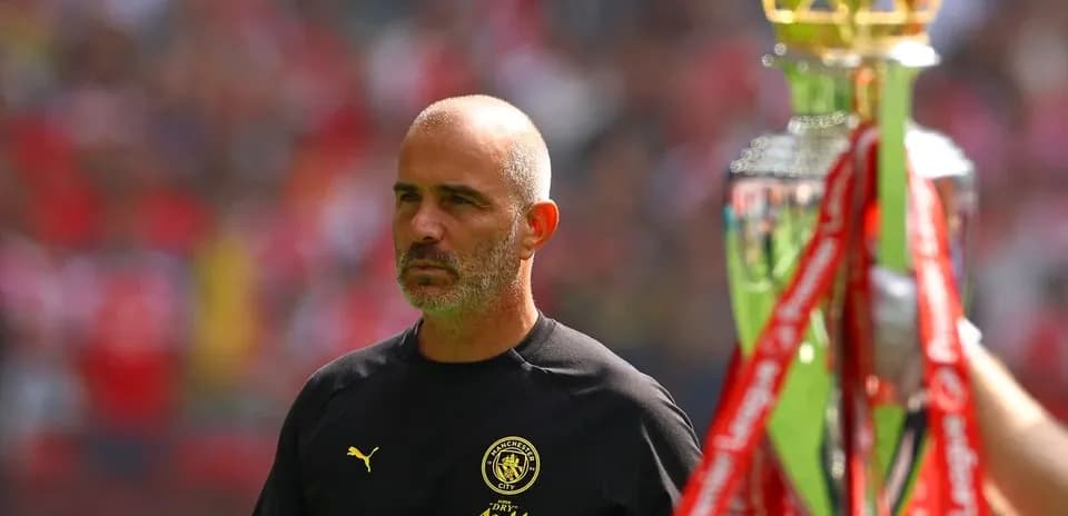 Manager walking past trophy before match