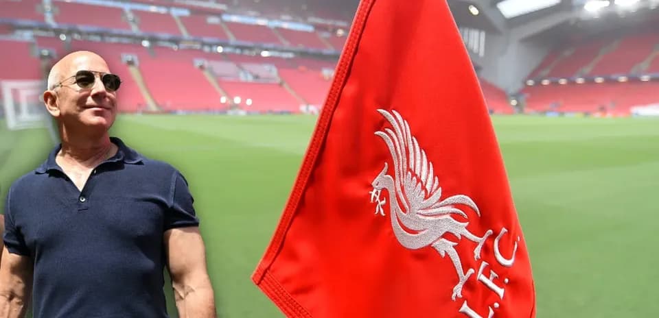 Man beside Liverpool flag at stadium
