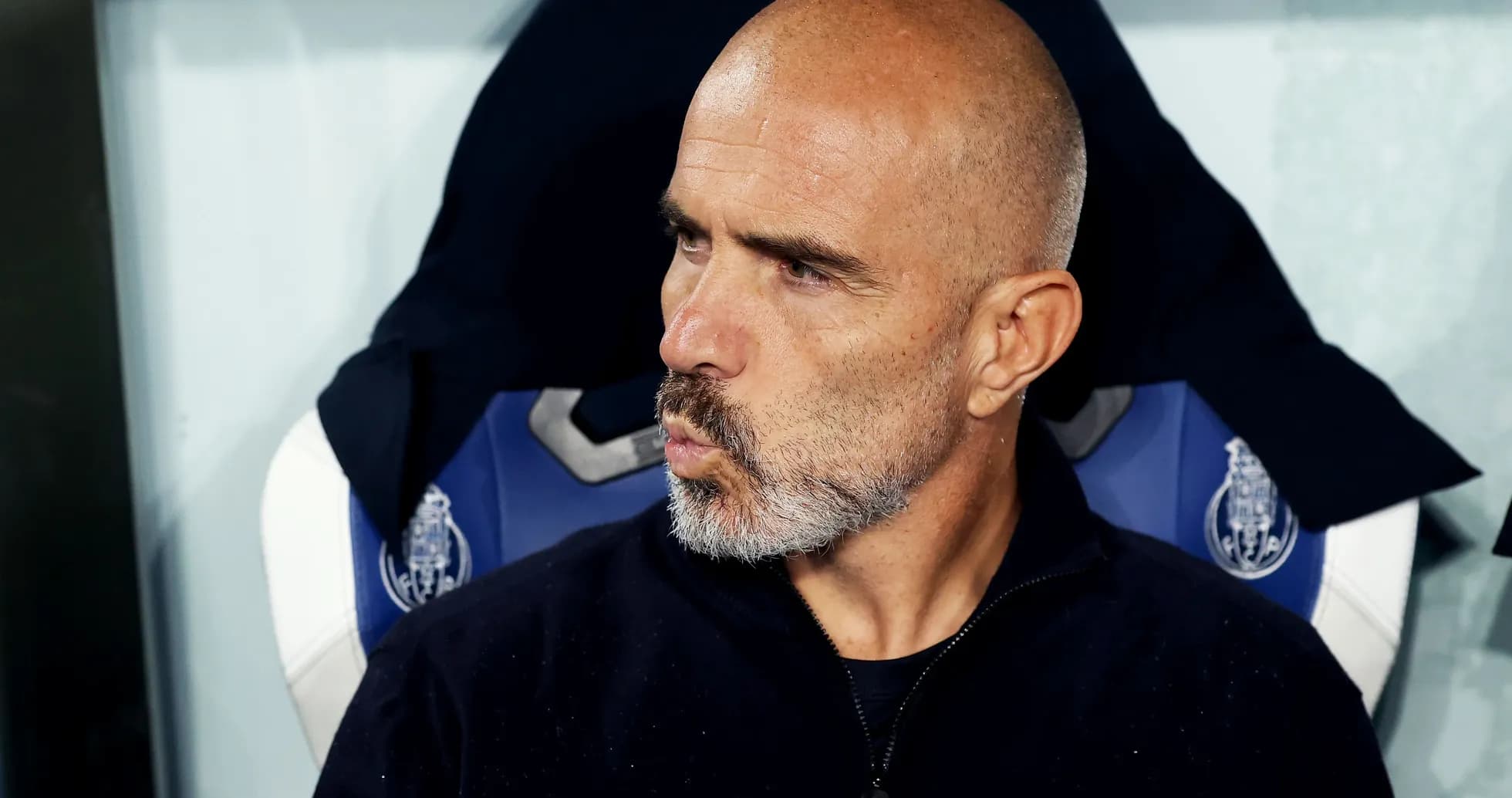 Coach sitting on bench during match observation