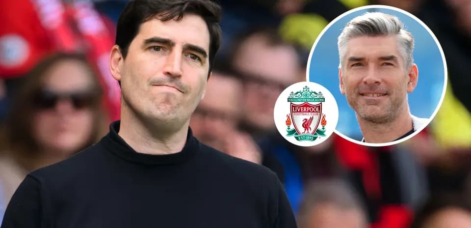 Coach observing match with Liverpool logo in corner