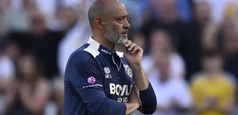 Coach observing match with hand on chin