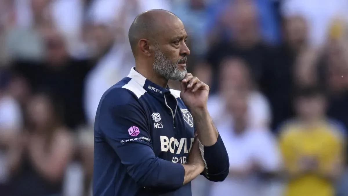 Coach observing match with hand on chin