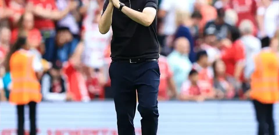 Manager applauding fans after the match