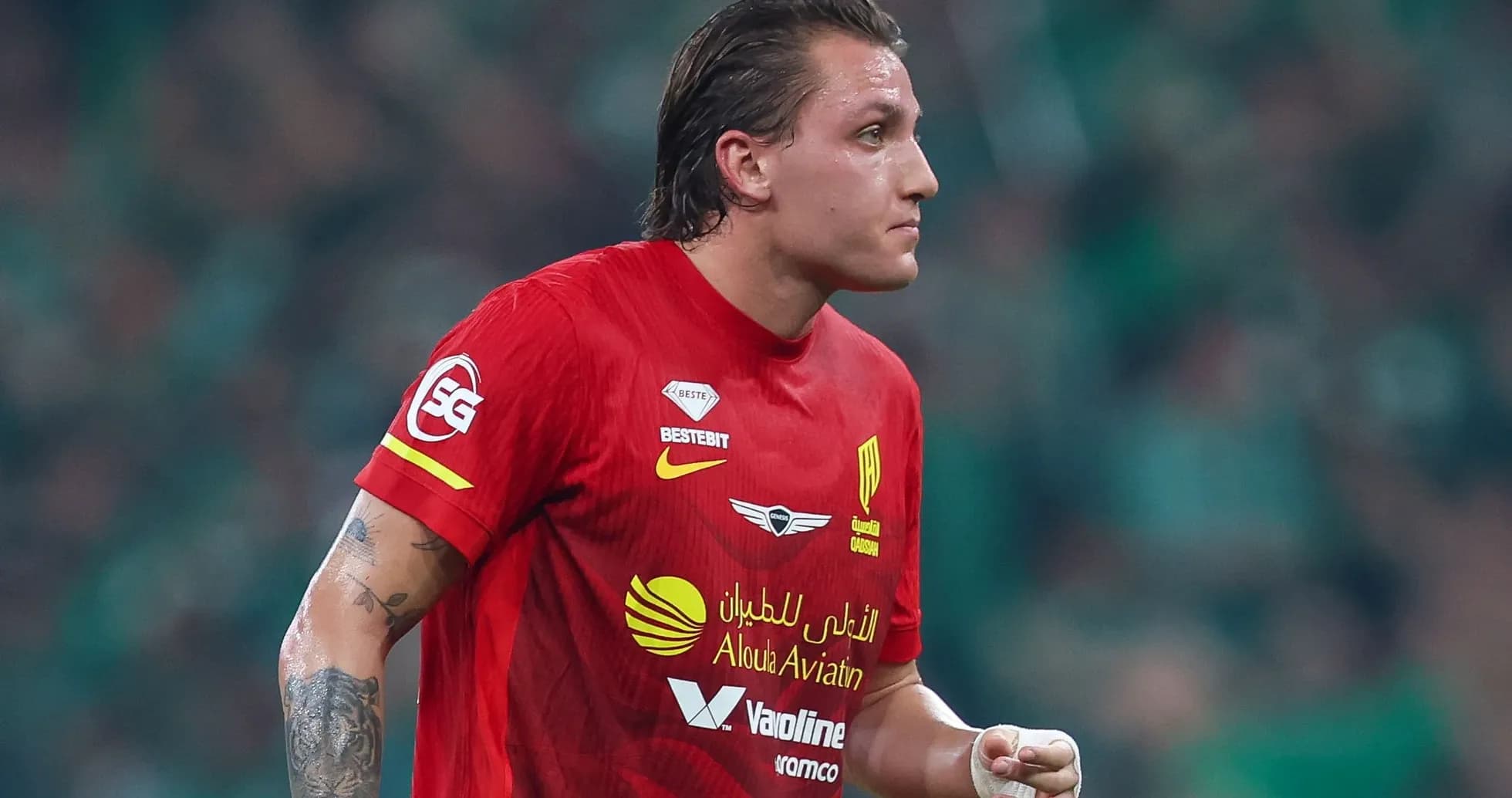 Player in red jersey during football match