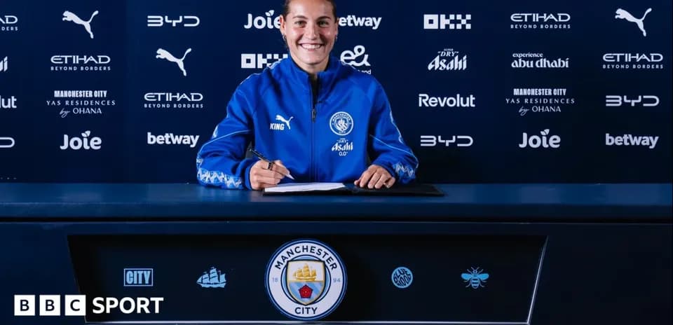 Player signing contract at Manchester City press conference