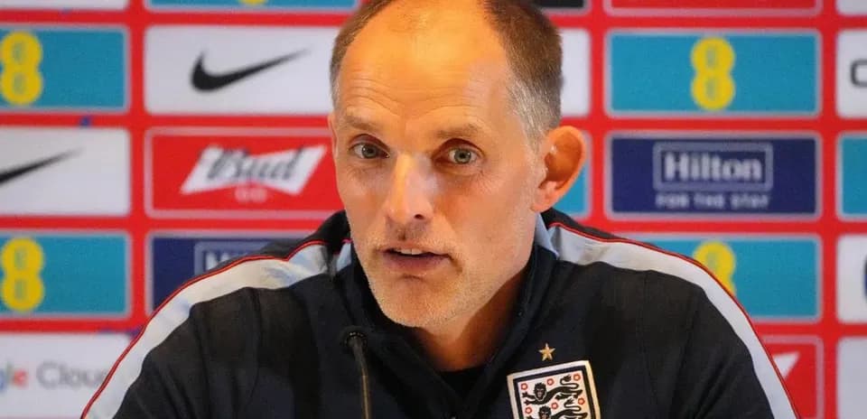 Manager speaking at press conference with branding backdrop
