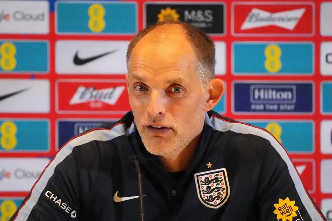 Manager speaking at press conference with branding backdrop
