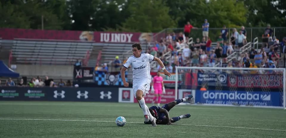 Player dribbling the ball during football match