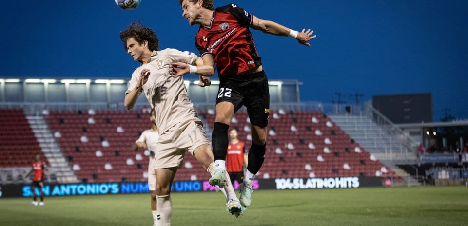 Players contesting for the ball in FC Tulsa match