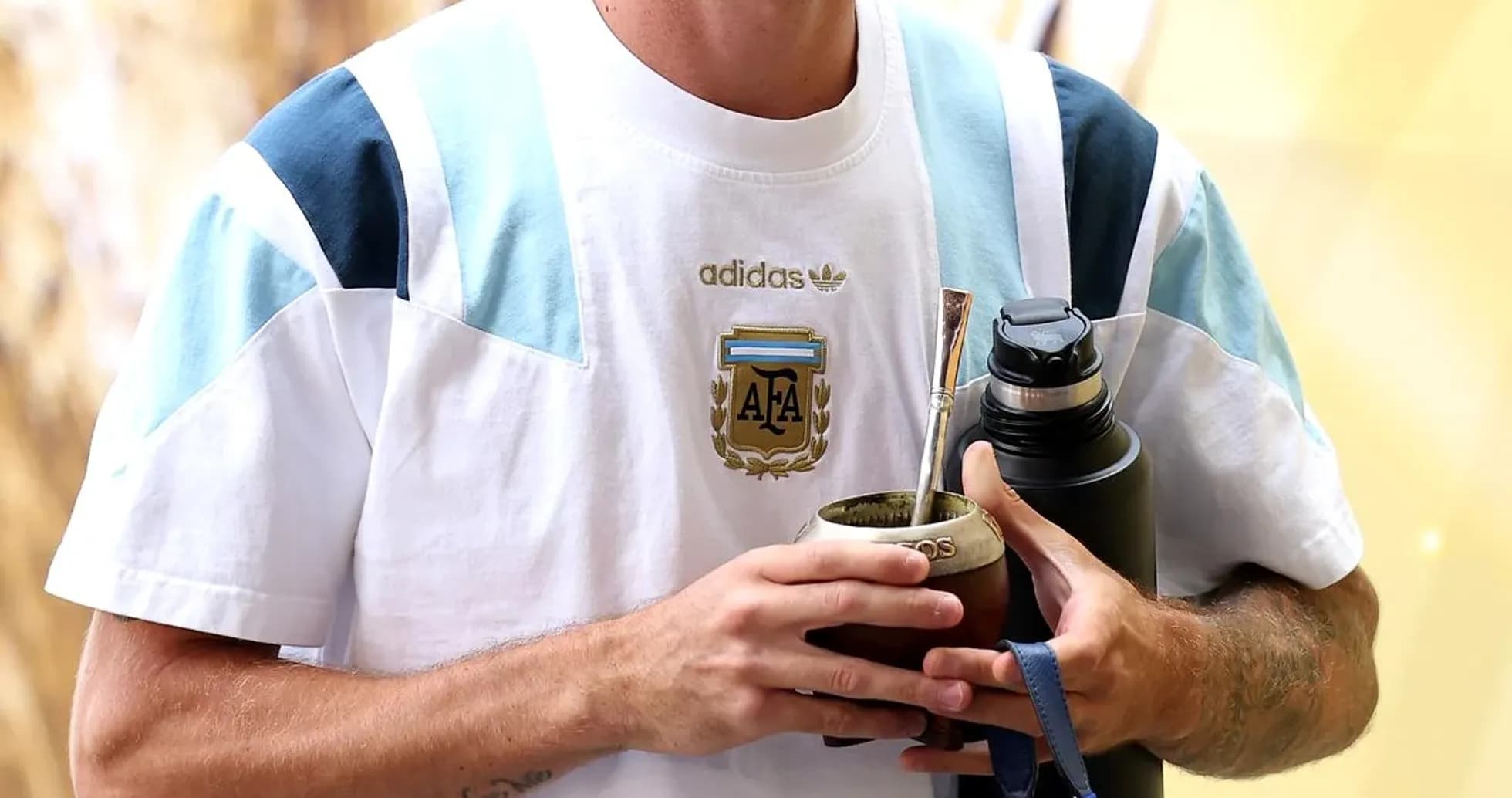 Player holding mate and water bottle at venue