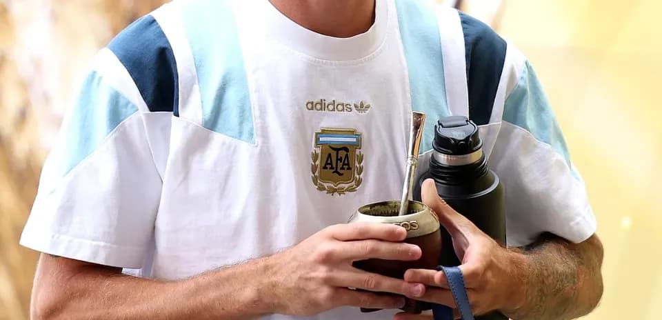Player holding mate and water bottle at venue
