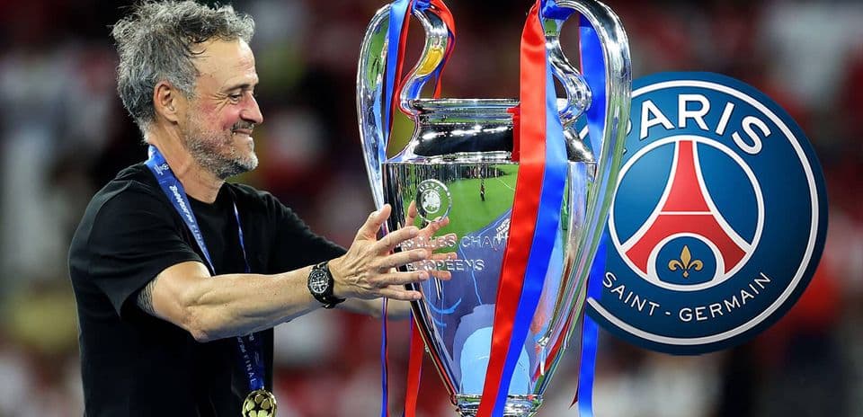Coach holding UEFA Champions League trophy with ribbons