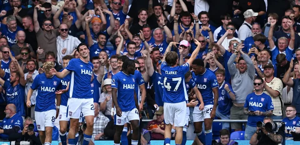 Ipswich players celebrating a goal with fans