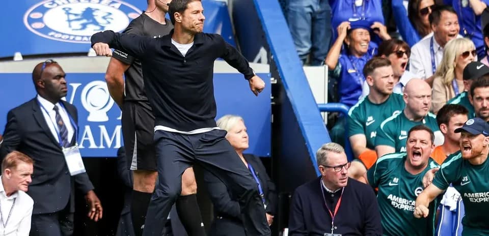 Coach celebrating a goal on the sidelines