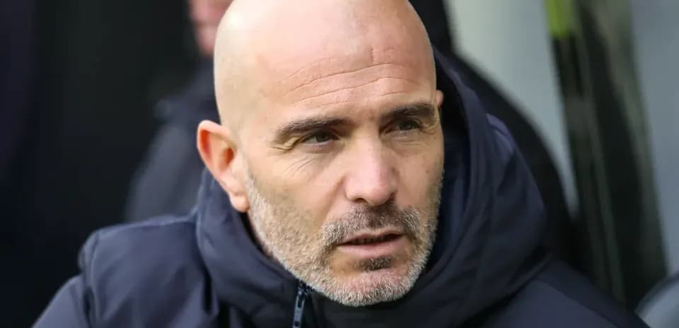 Coach sitting on the bench during a match