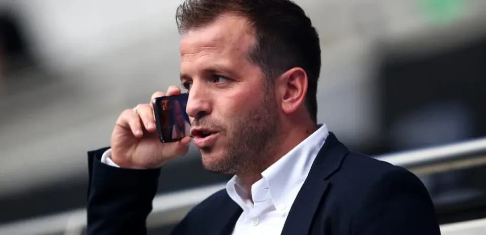 Person speaking on a mobile phone in a stadium