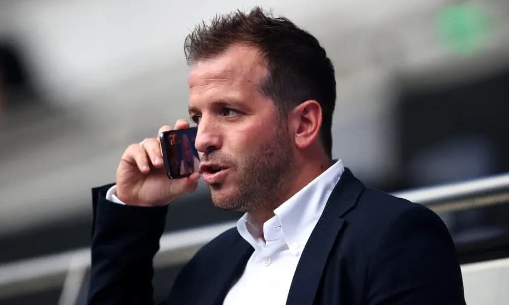 Person speaking on a mobile phone in a stadium