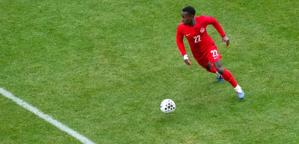 Canadian player sprinting with the ball