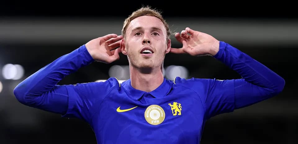 Player celebrating with hands behind ears in blue jersey