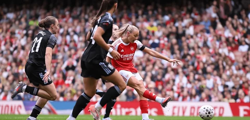 Arsenal player shooting during match against Aston Villa