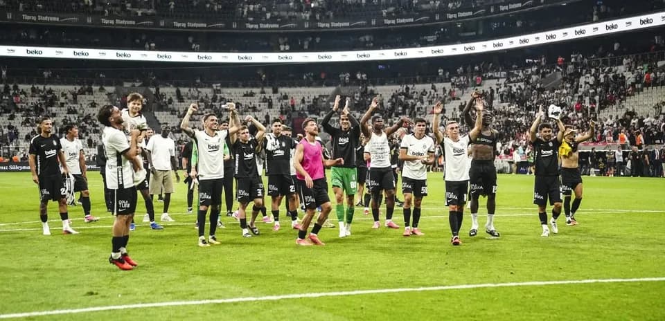 Beşiktaş players celebrating victory on the pitch