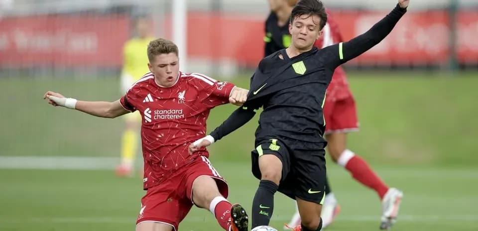 Two players competing for the ball in match