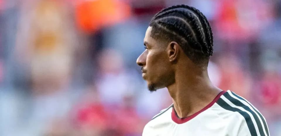 Player with braided hair during warm-up on field